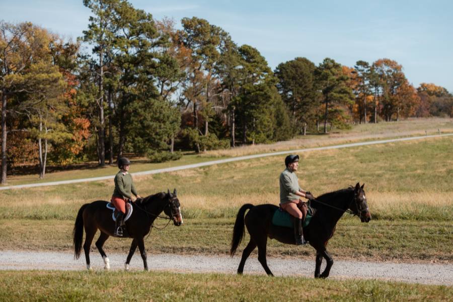 Two people on a trail ride at L'auberge