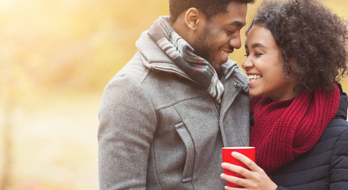 a couple outside with a hot drink at our romantic virginia boutique hotel