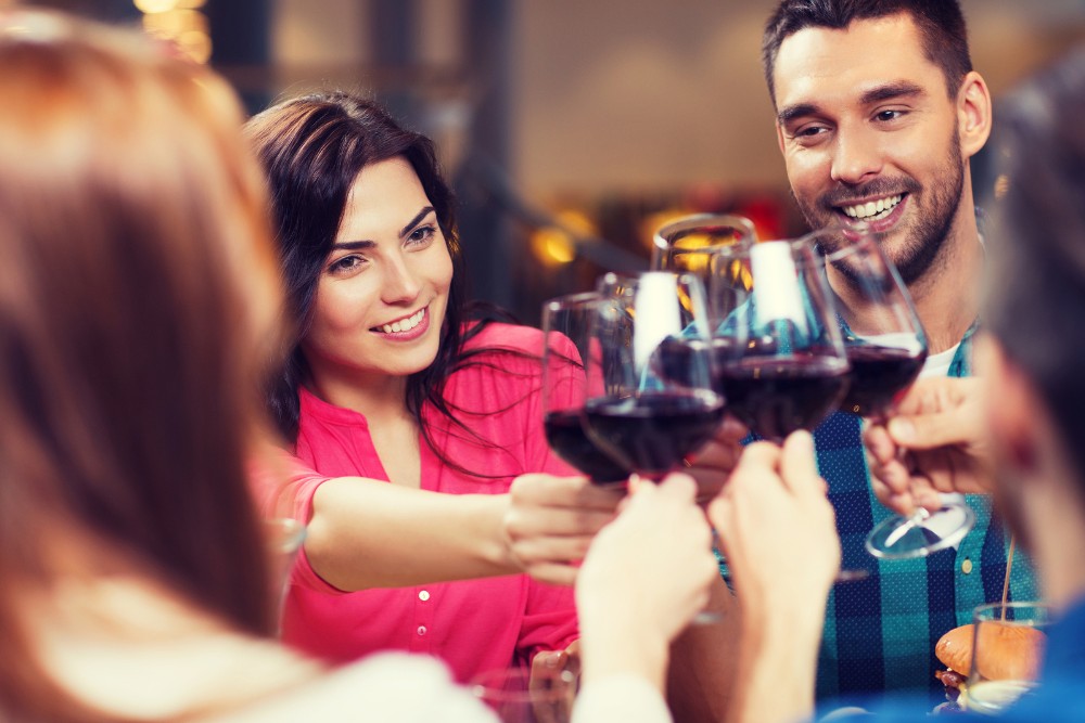 group of friends toasting with red wine