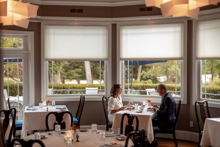 Two people sitting by a window in a restaurant